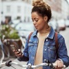a woman on a bike looking at her cell