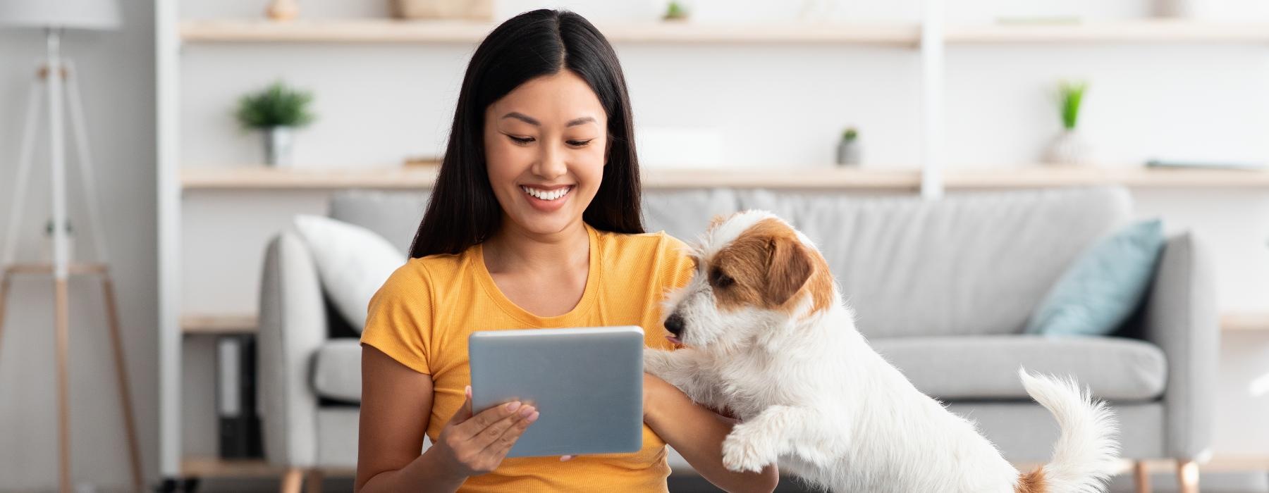 a woman sitting on the floor with a dog