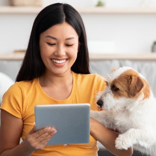 a woman sitting on the floor with a dog