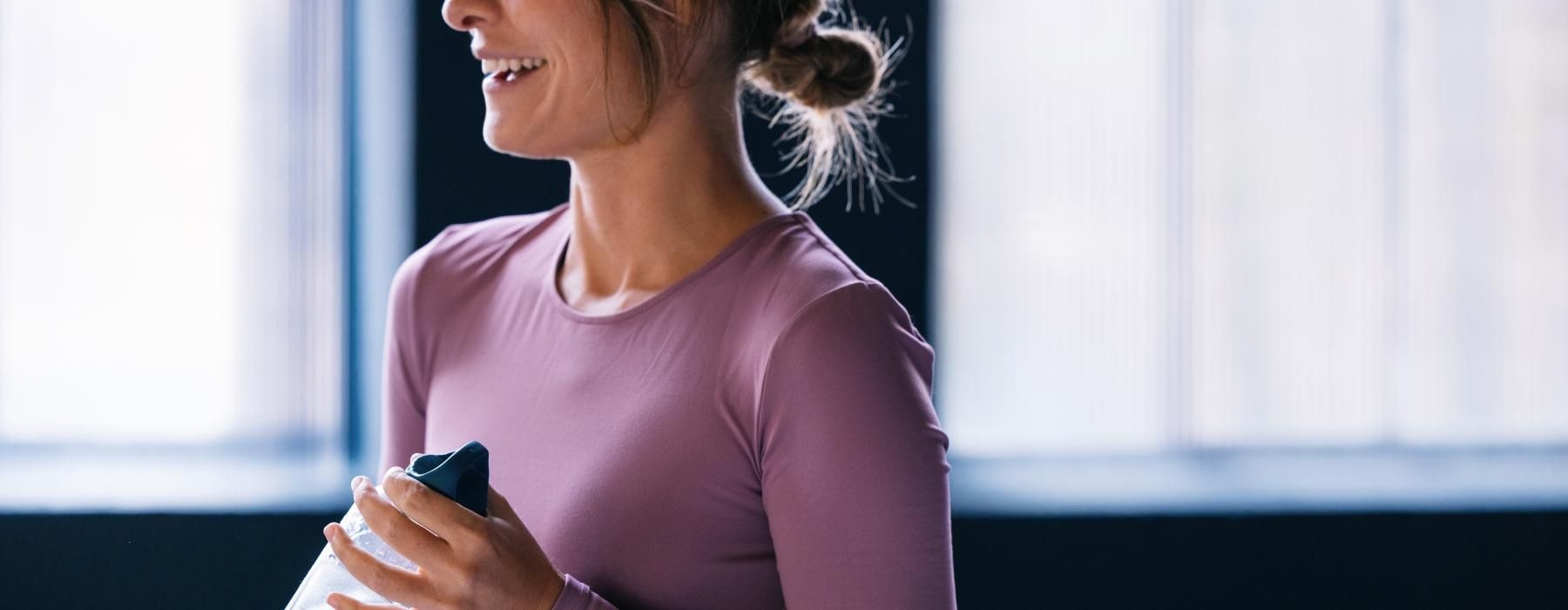 a woman holding a water bottle